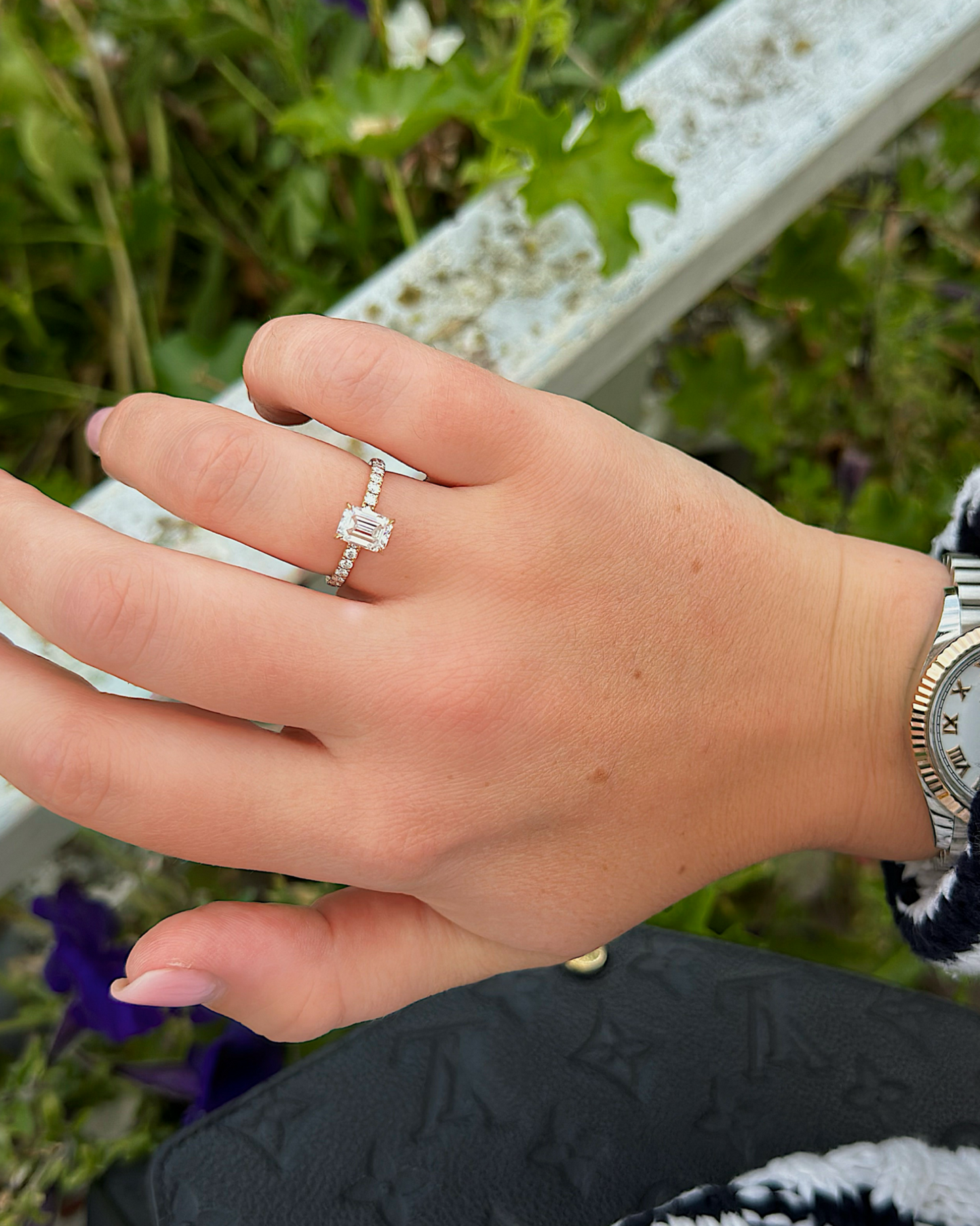 Tilda - 18K Gold Emerald Cut Verlobungsring mit Pavébesetzter Ringschiene, getragen an der Hand